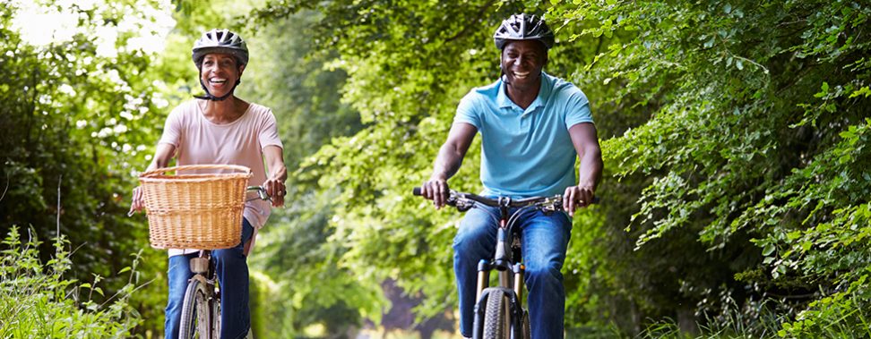 Mature African American Couple On Cycle Ride In Countryside