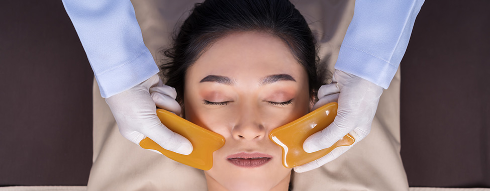 Woman-Receiving-Gua-Sha-Skincare-Treatment